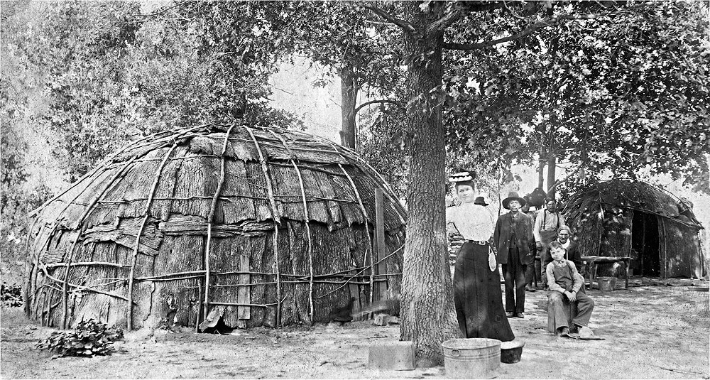 Andrew Magozee family with wigwam constructed from sapling and bark on Kickapoo reservation in Kansas, dated 1905.  From https://digital-exhibits.mchistory.org/digital-exhibits/making-a-home/the-kickapoo