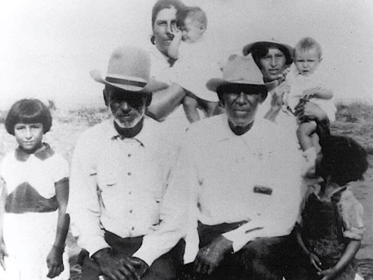A family photo shows Rosendo Mesa, left, and Longino Flores, right, and other residents in Porvenir, Texas. Longino Flores was among the 15 men and boys killed in the 1918 massacre. Source: El Paso Times.