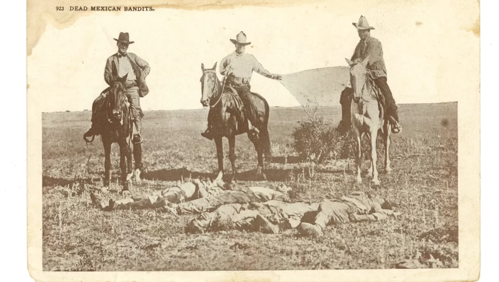 A 1915 postcard titles “Dead Mexican Bandits” shows three Texas Rangers on horseback, gazing at the bodies of Jesús García, Mauricio García, Amado Muñoz, and Muñoz's brother, killed in retaliation for their alleged participation in an attack on the King Ranch. Photograph: El Paso Times, https://www.elpasotimes.com/story/news/local/el-paso/2016/01/16/museum-exhibit-explores-borders-bloody-past/78743194/.